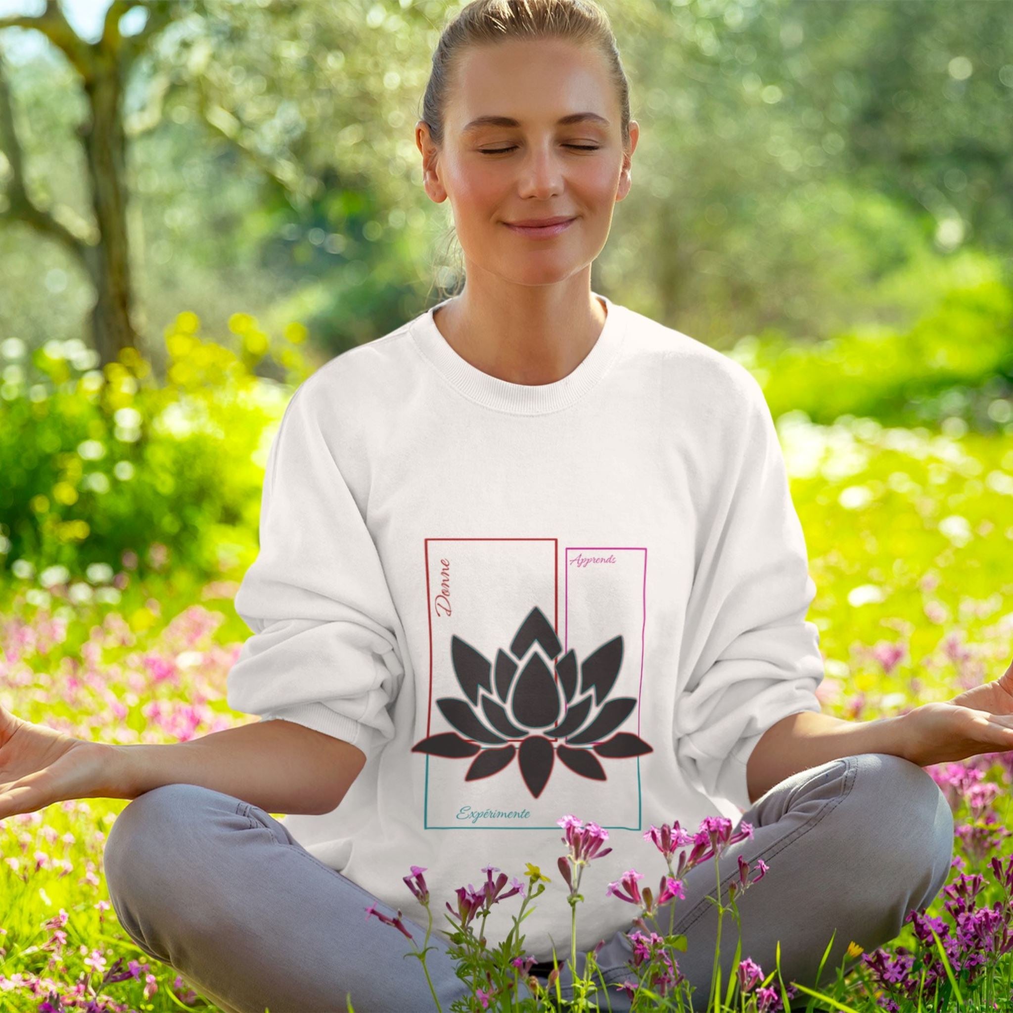 Sweat-shirt unisexe, avec texte de développement personnel sur la partie ventrale, apprend, expérimente, donne, sur rectangles couleur rouge, bleu turquoise, violet, associés au symbole du lotus en transparence, fond blanc. Logo imprimé Flame and Spirit sous la nuque.
