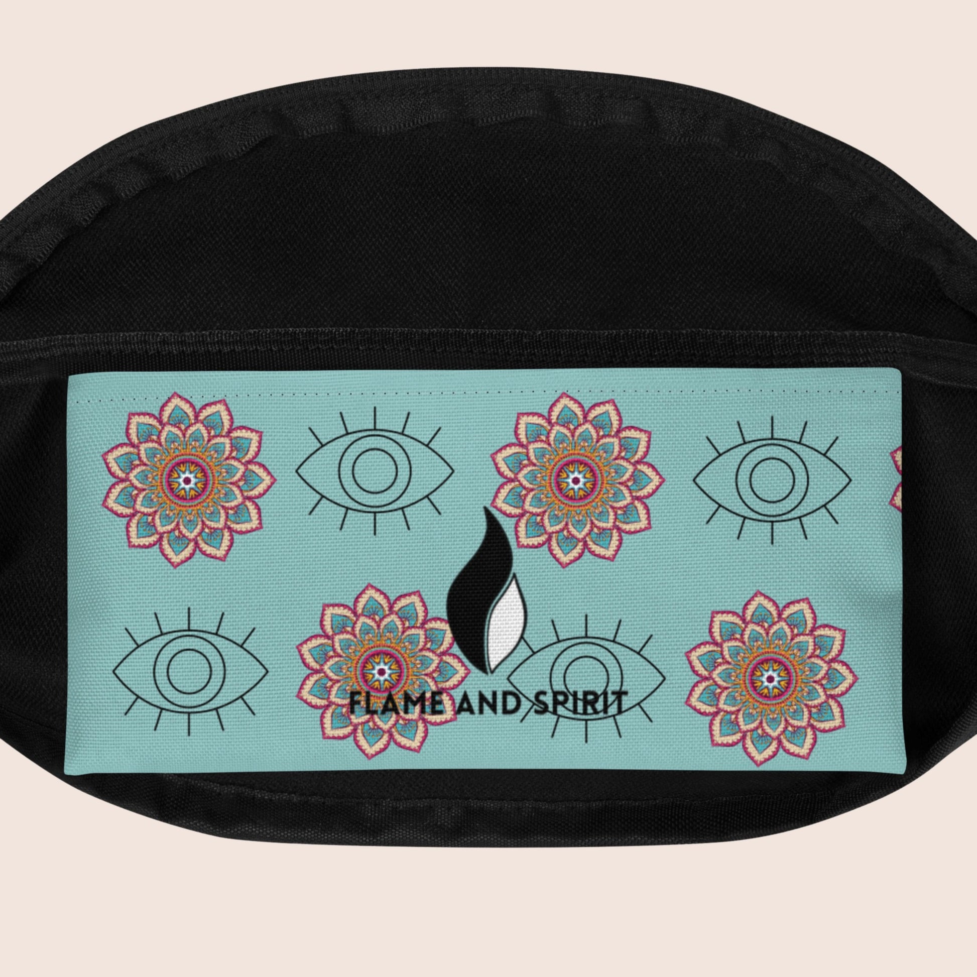 Sac Banane  non genré, avec affirmation positive sur la poche supérieure. Motifs œil graphique et mandala sur fond bleu vert clair. Signature Flame and Spirit face avant et poche intérieure.